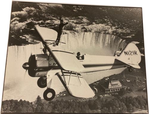 Lot # 25.11 Undated, Daredevil stands on plane flying over Niagara Falls
