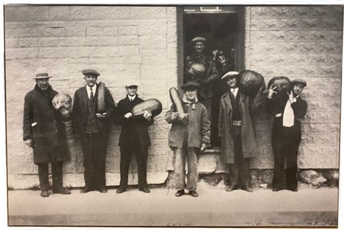 Image for Lot #40.5 Men holding produce Image mounted on board Floating from wall backing